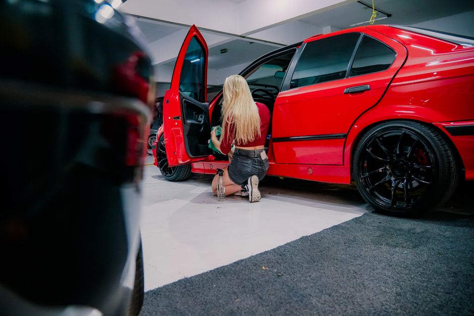 Detailer performing meticulous interior detailing on leather seats